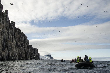 Man & Nature Svalbard,sea,cliffs,boat,boats,people,camera,photographer,snow,dinghy,birds,birdwatchers,birdwatching,auks,guillemots